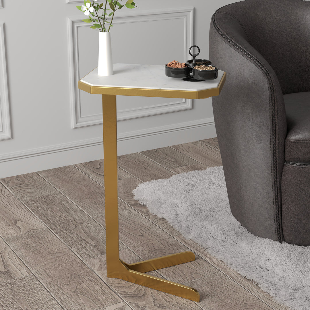 The c-shaped design of the table fits perfectly over a sofa or chair arm, making it the perfect addition to any living space. The modern two pronged base gives it a sleek and contemporary look, while the brass finish adds a touch of elegance. The marble top adds a touch of luxury to this piece and makes it a perfect addition to any room. Whether you're looking to add a touch of elegance to your living room or want to add a functional piece to your bedroom, this accent table is the perfect choice.